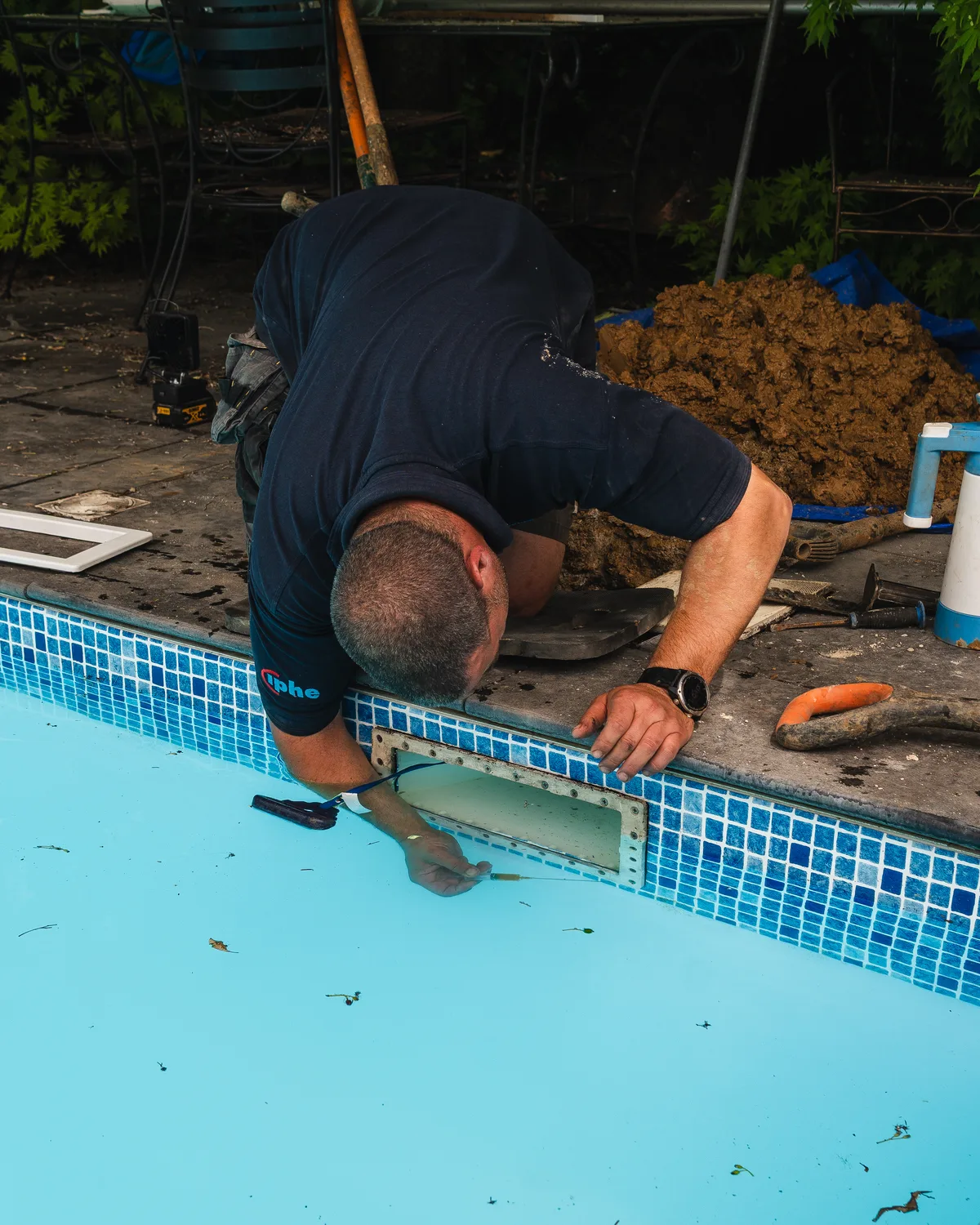 ADI engineer inspecting the edge of a swimming pool